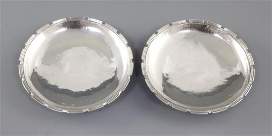 A pair of 1930s Arts & Crafts silver crenelated dishes, by Omar Ramsden, Diameter 4 ½”/114mm Combined weight 6.8oz/194grm